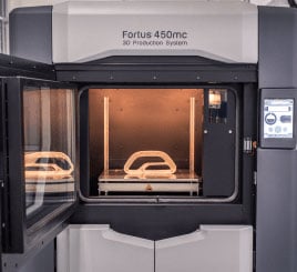 A machine making prototypes for additive manufacturing & engineering services